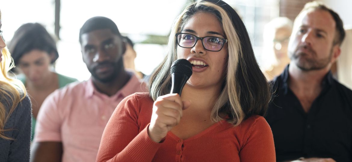 Closeup of a woman speaking on a microphone