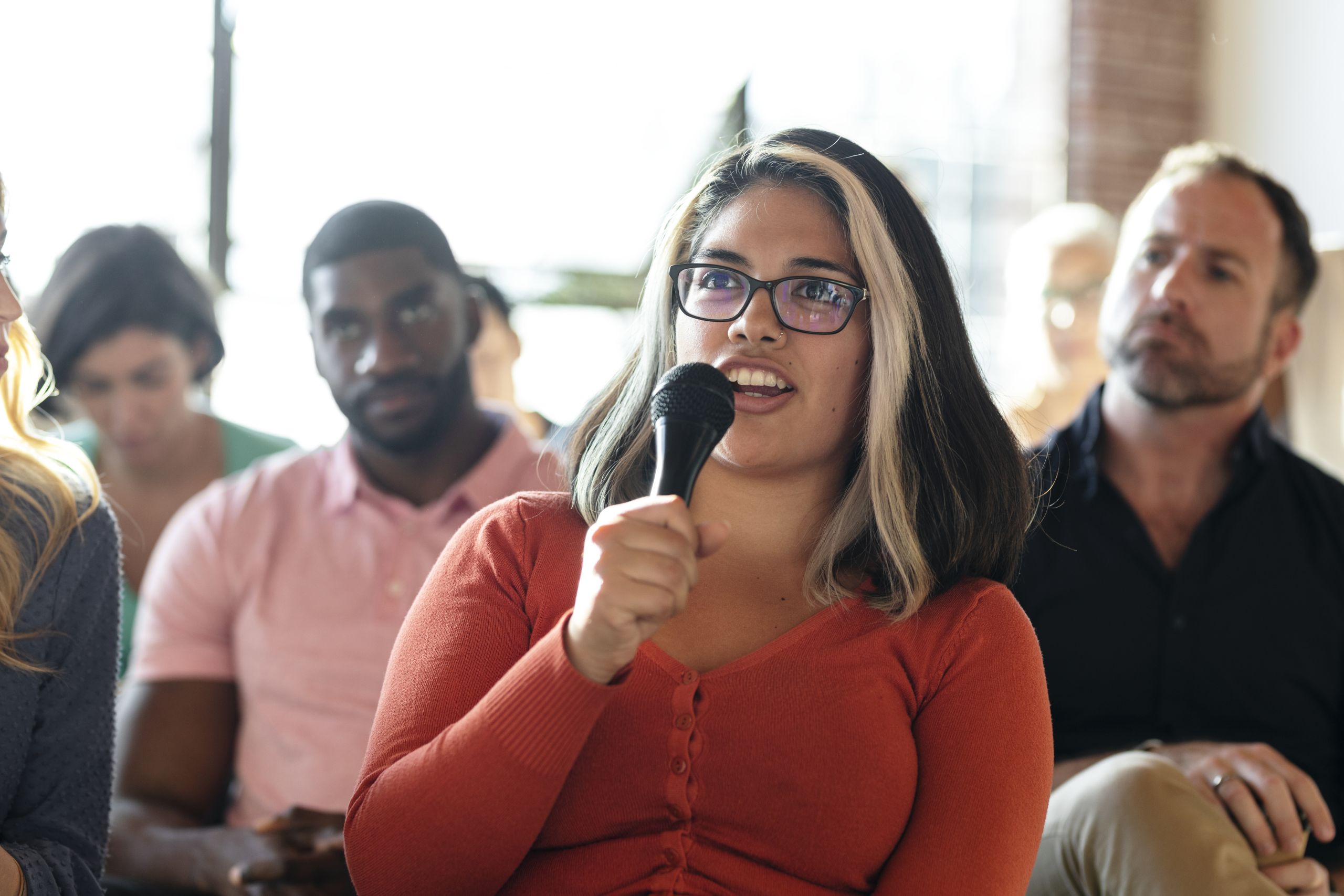 Closeup of a woman speaking on a microphone